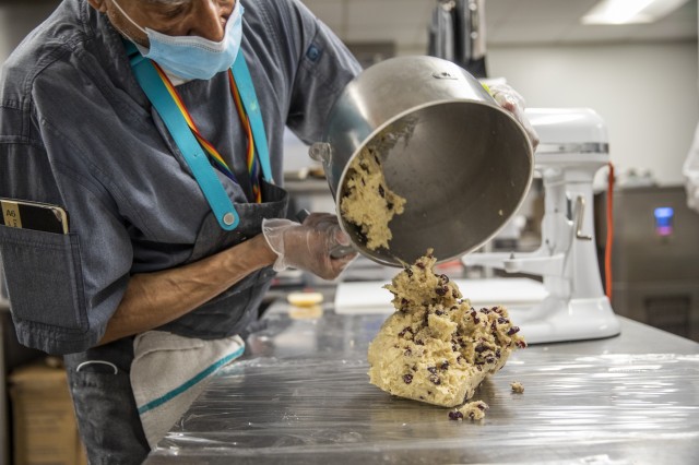 Pouring dough out of mixer 