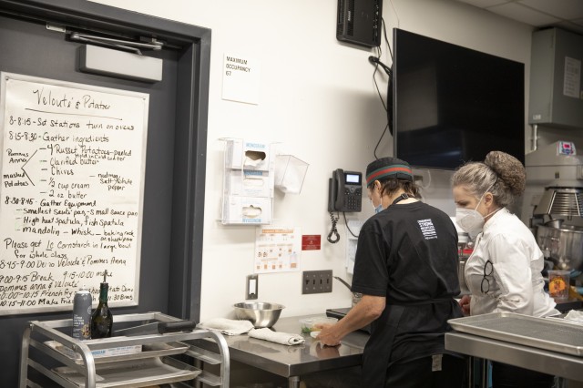 Two people in training kitchen 