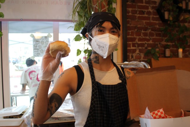 Women with mask holding bread 