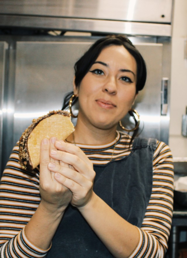 Woman holding ice cream in kitchen 