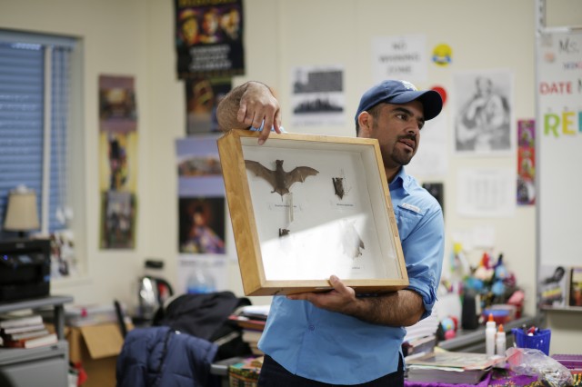 Miguel Ordeñana holds up a box of bat specimens.