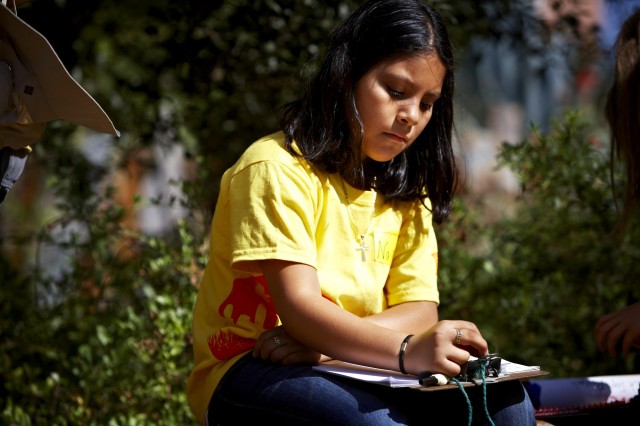 student journaling outside