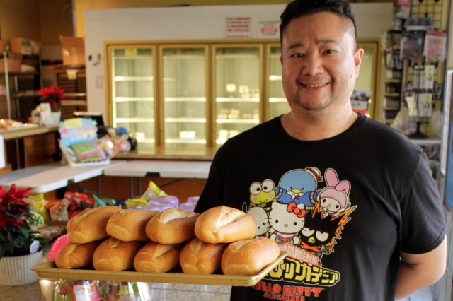 Man holding Bahn Mi Rolls on tray 