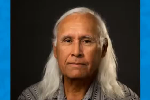 Portrait of Alan against a black background