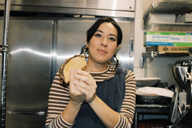 Woman holding ice cream in kitchen 