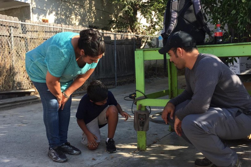 Me helping NHMLA SuperProject Participants to install a camera trap in their backyard in South Central Los Angeles.  photo: Lisa Gonzalez