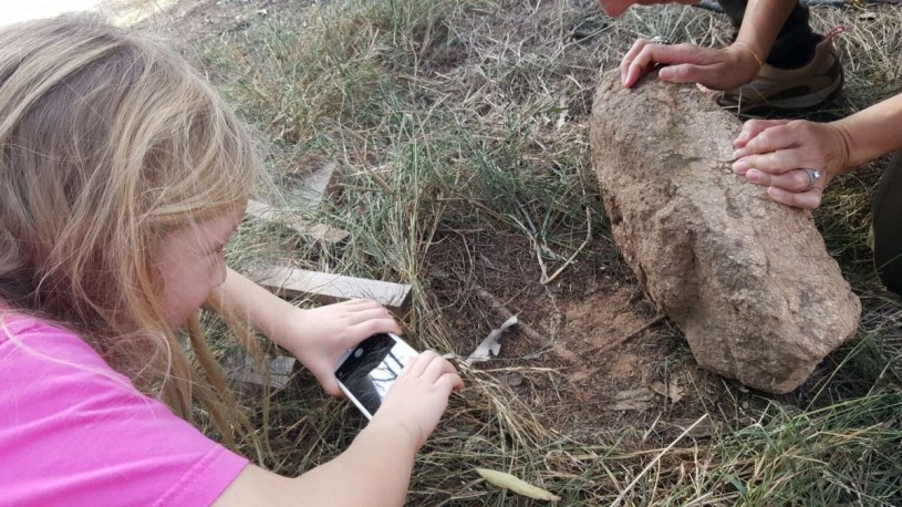 Charlotte and Amelia check under the pink glowworm rock