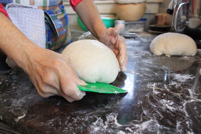 Karen rounds her sourdough 