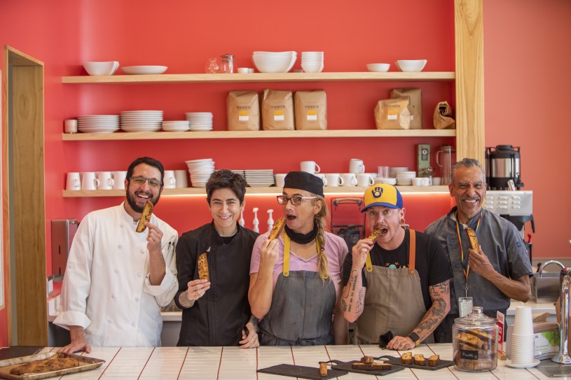 group of people in a cafe holding biscotti