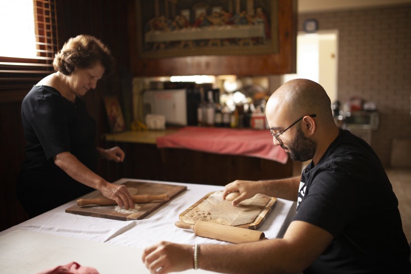 Woman and man making bread on kitchen table