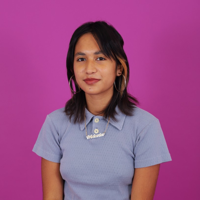 Person wearing purple shirt on bright background