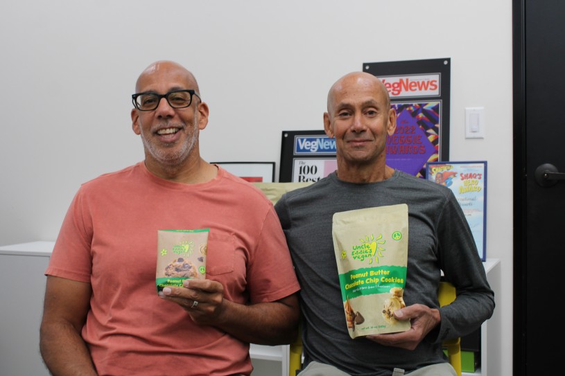 two men holding bags of cookies