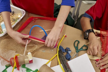 mesh produce bag being stretched and shaped with pipe cleaners to create sifter