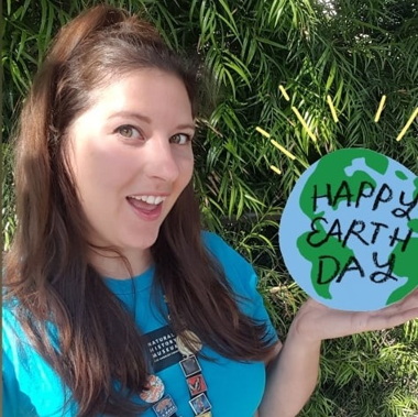 Woman holing happy earth day globe 